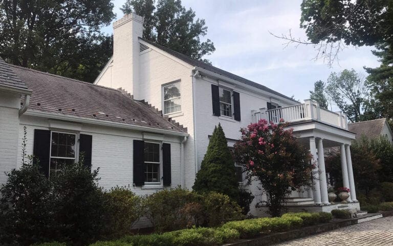 Gutters installed on a white brick home in Chevy Chase, Maryland