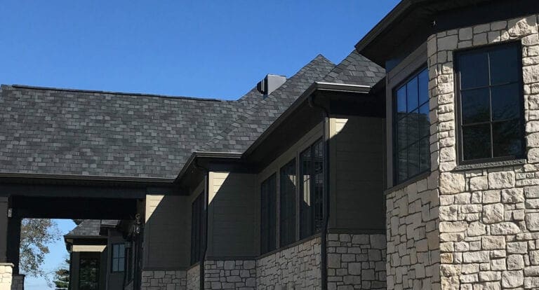 Black K-style seamless gutters on a stone and siding home in McLean, VA