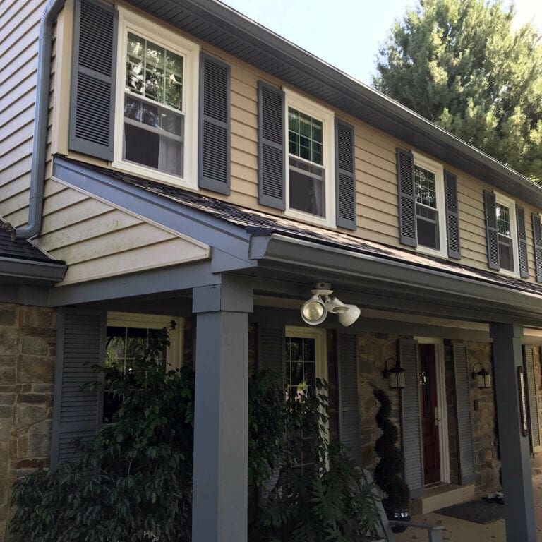 Two-story home with new fascia, trim and seamless gutters over the front porch