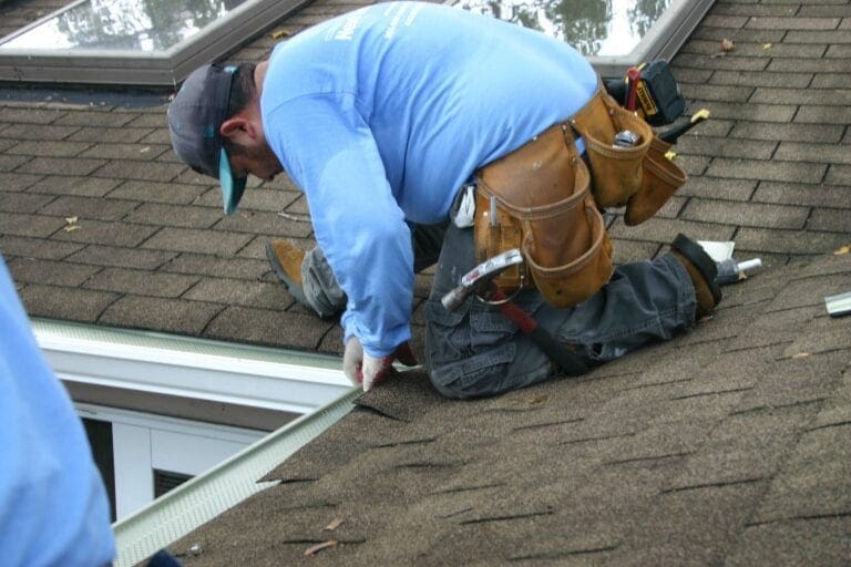 Installer fitting Leaf Relief gutter guards along a roof edge