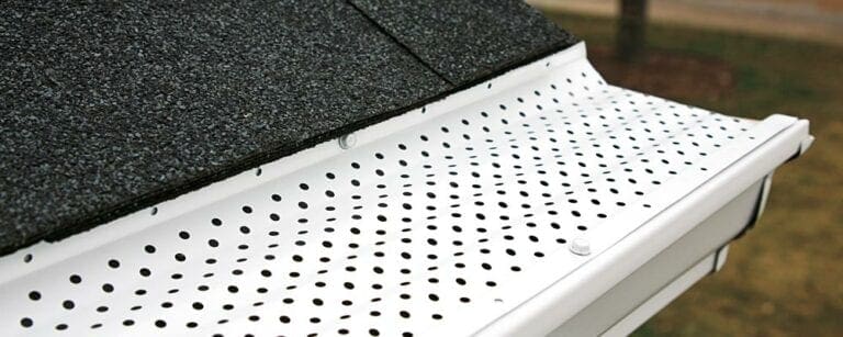 Close-up of a Bulldog gutter guard over a white gutter