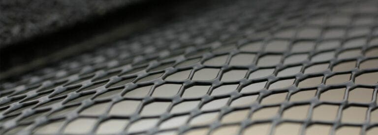 Black expanded-metal gutter screen over a gutter
