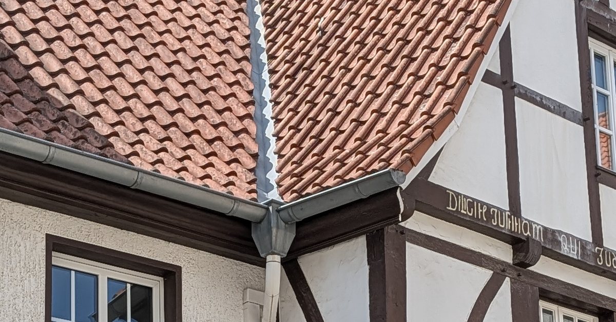 Zinc half round gutter and round downspout on a traditional half-timbered building in Germany
