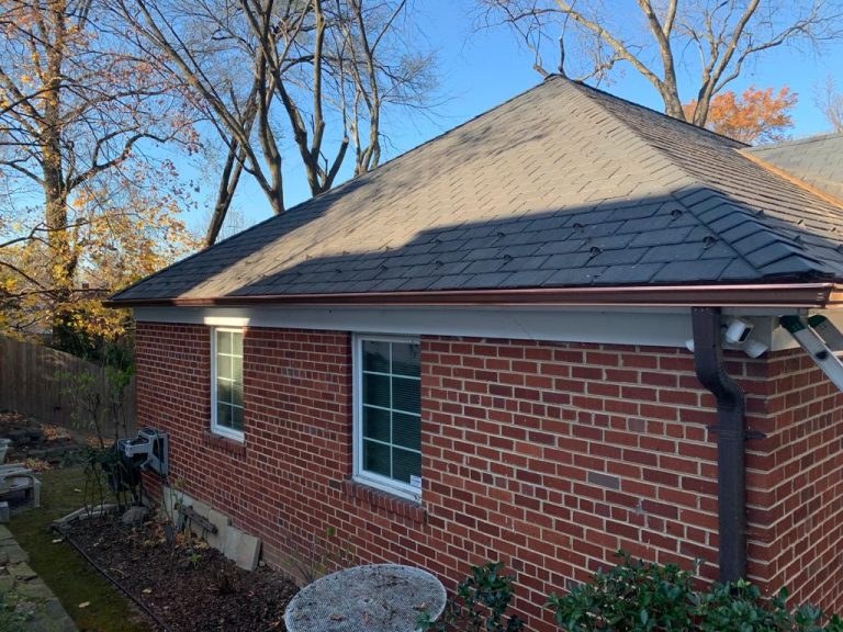 Brick rambler with a copper K-style gutter along the eave